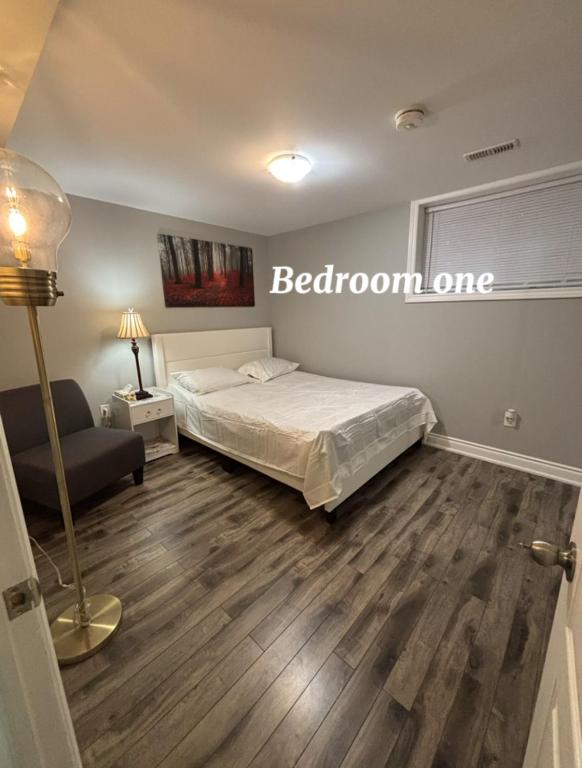 a bedroom with a bed and a sign on the wall at Fully Furnished 2 Bedroom Apartment in Kitchener