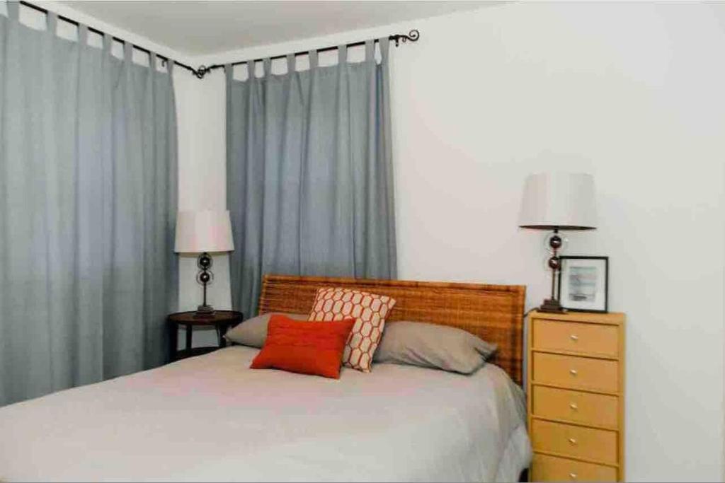 a bedroom with a bed with two pillows on it at Cottage Apartment by Lake MI w private Hot Tub! 