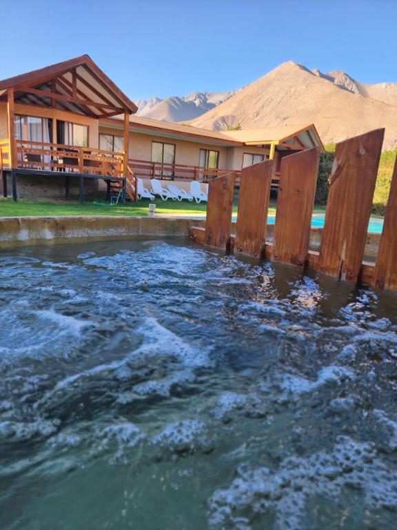 a pool of water in front of a house at Luna en San Isidro 