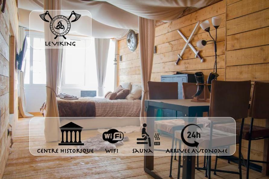 a room with a bed and a table in a room at Le Viking in Besançon
