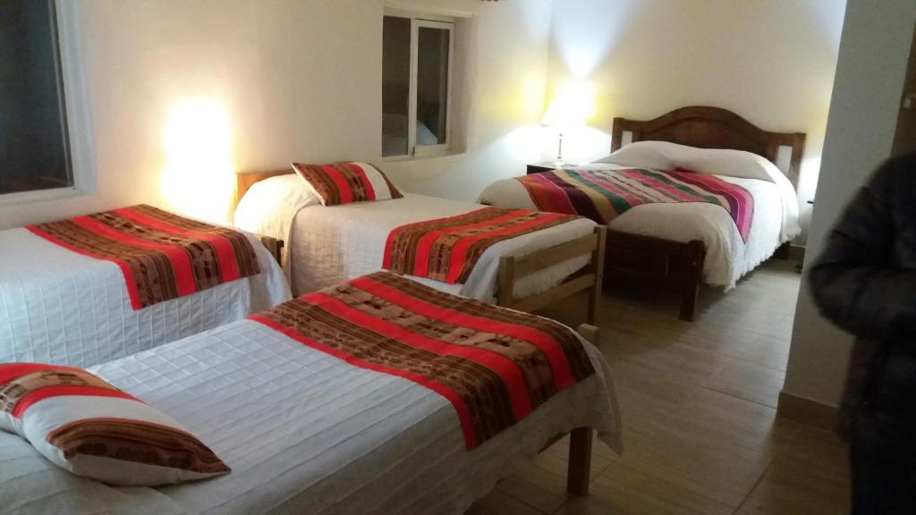 Postel nebo postele na pokoji v ubytování Hostal Nuevo Amanecer