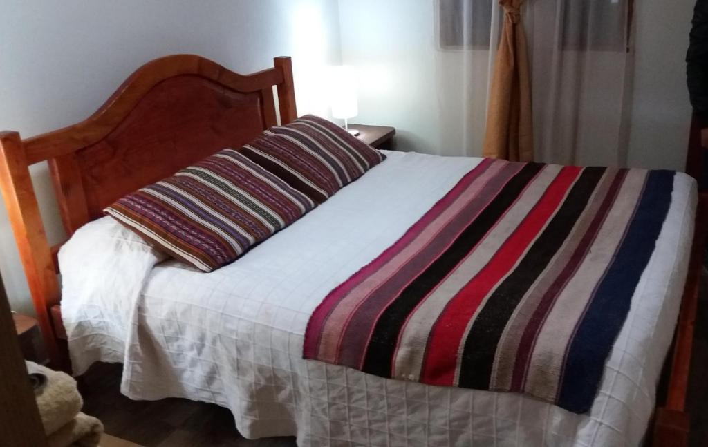 Postel nebo postele na pokoji v ubytování Hostal Nuevo Amanecer