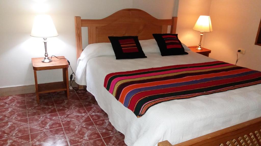 Postel nebo postele na pokoji v ubytování Hostal Nuevo Amanecer