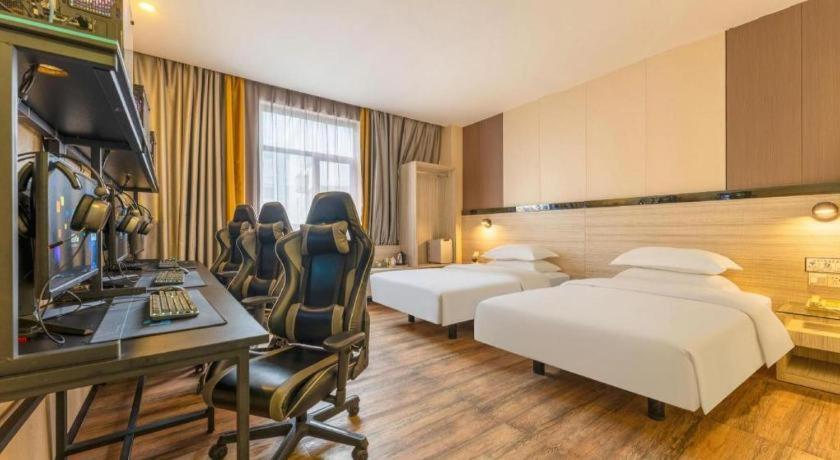 Postel nebo postele na pokoji v ubytování Wenxing Hotel Dongguan Qifeng Branch