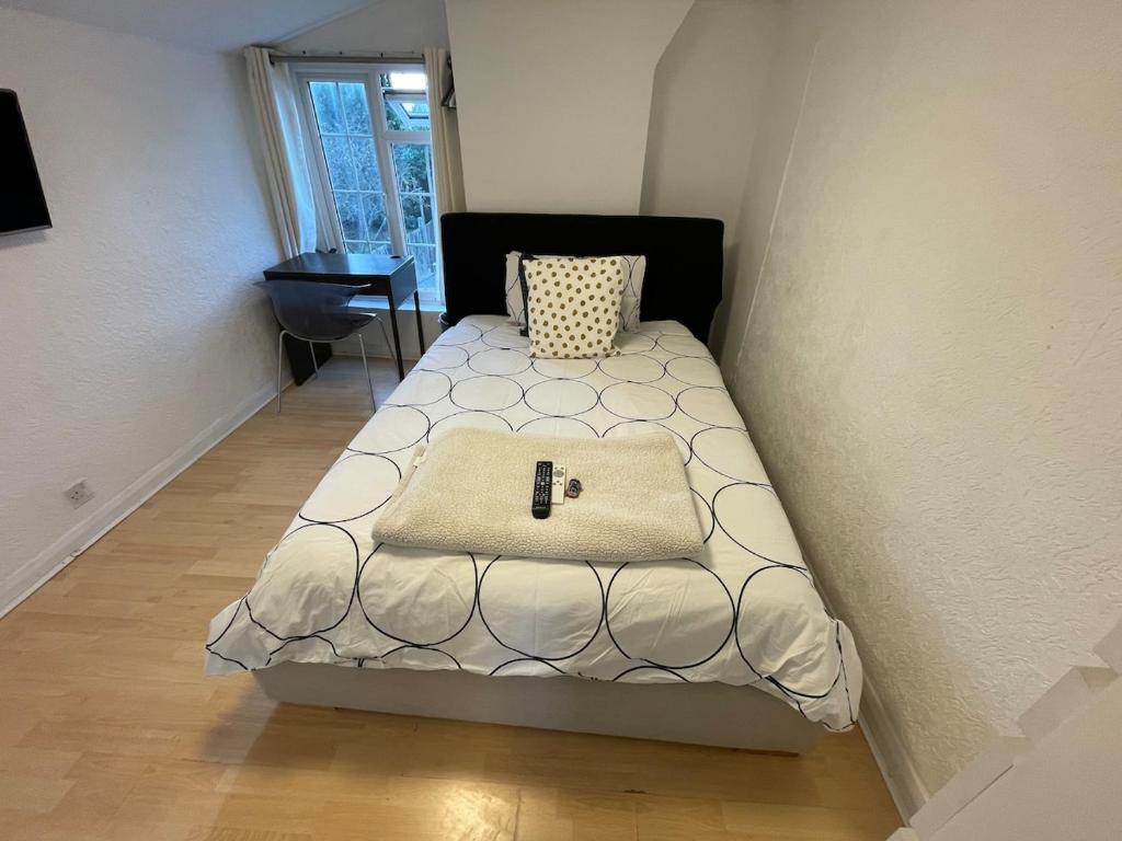 a small bedroom with a bed in a corner at 96TR Double bed bedroom - Edmonton green in Edmonton