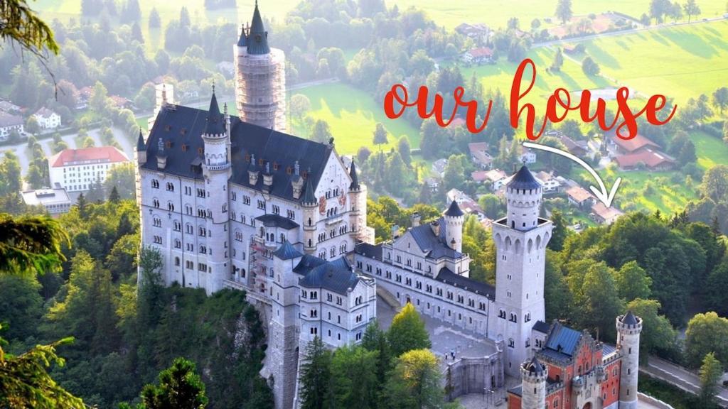 a castle on a hill with the words our house at King Ludwig's Old Neighbour in Schwangau