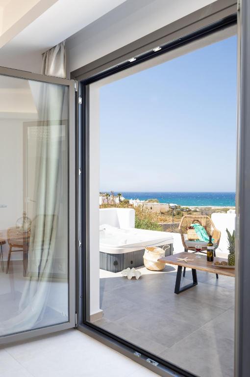 a sliding glass door in a living room with a view of the ocean at BLUE SEA Naxos in Stelida