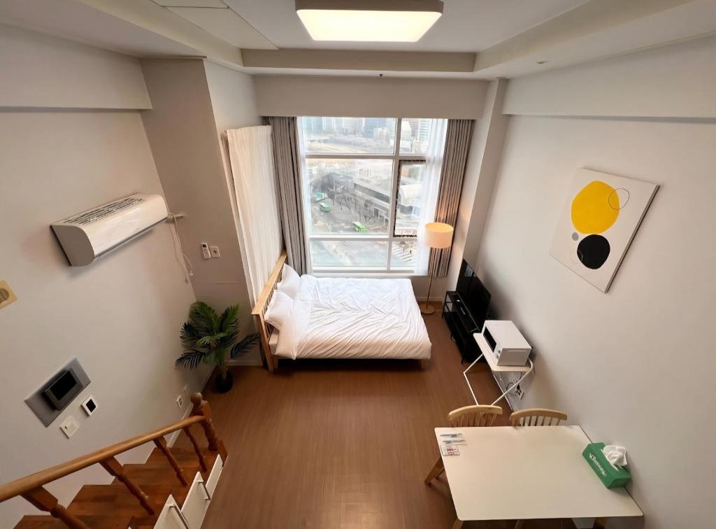 une petite pièce avec un lit et une fenêtre dans l'établissement Seoul Station Urban View Room, à Séoul