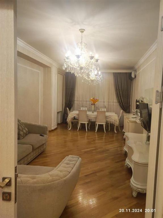a living room with a chandelier and a piano at Baku in Baku