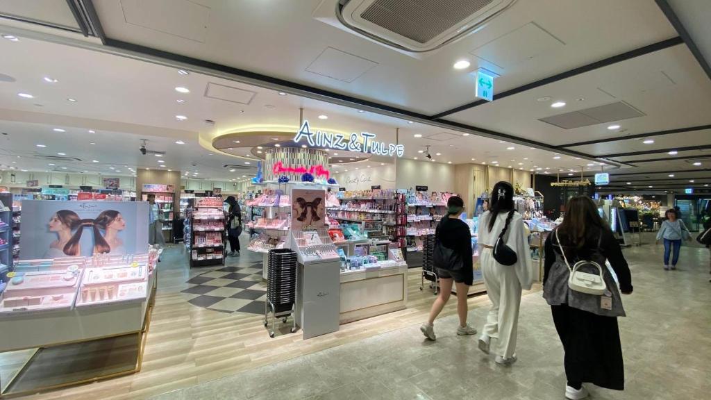 a group of people walking through a shopping mall at THE CAMILLE PLACE Tokyo Edogawa has direct access to Akihabara and Shinjuku, with convenient transportation and free WiFi in Tokyo
