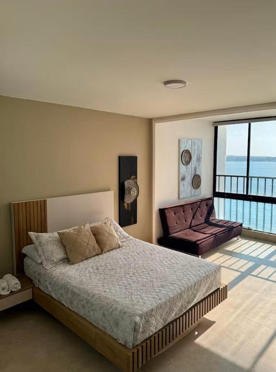 a bedroom with a large bed and a balcony at leslies apartamentos in Cartagena de Indias