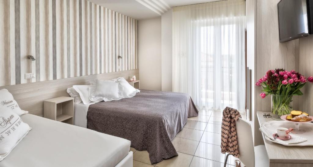 Postel nebo postele na pokoji v ubytování Hotel Clitunno