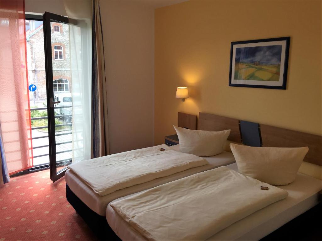 En eller flere senger på et rom på Hotel Ambiente