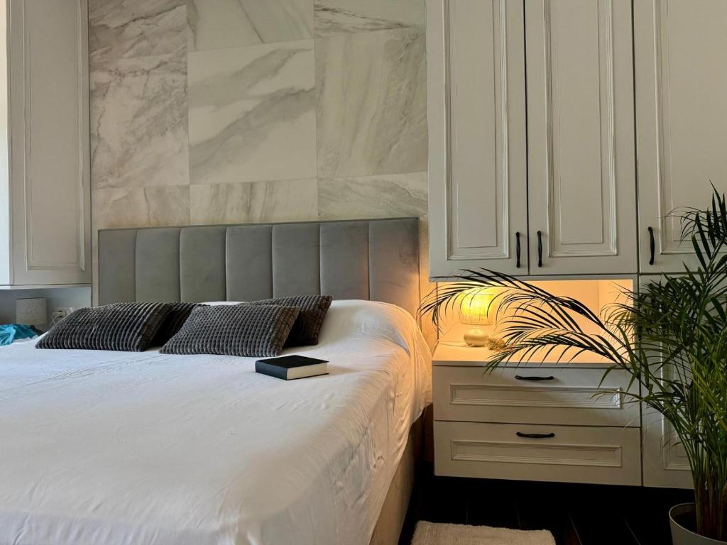 a bedroom with a bed with a book on it at Vila Brinje in Dol pri Ljubljani