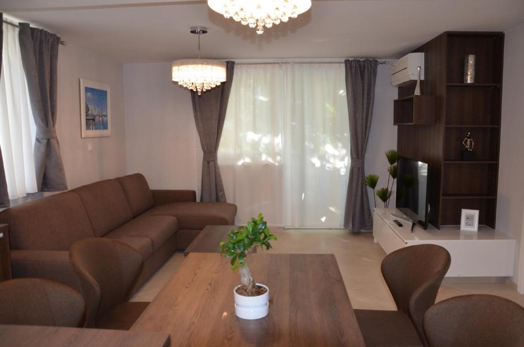 a living room with a couch and a table at Apartments Mango in Baška