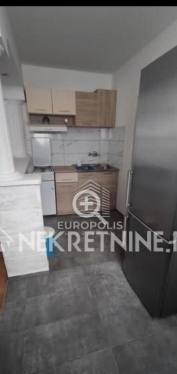 a small kitchen with a refrigerator in a room at Sandra Brend in Beograd