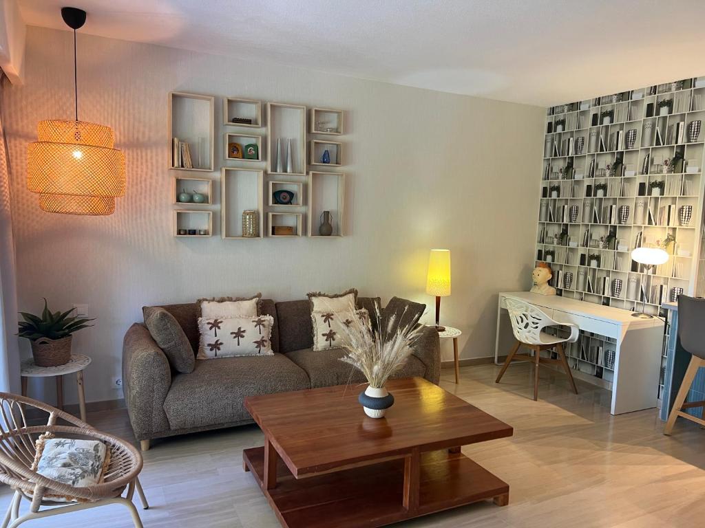 a living room with a couch and a table at BARAKA Suite BANUS in Marbella