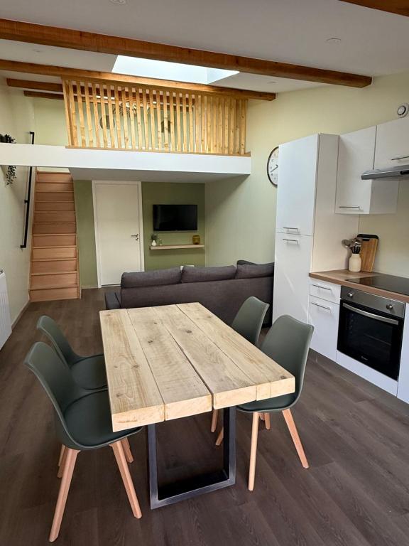 a living room with a wooden table and chairs at Duplex appartement en plein centre in Gérardmer