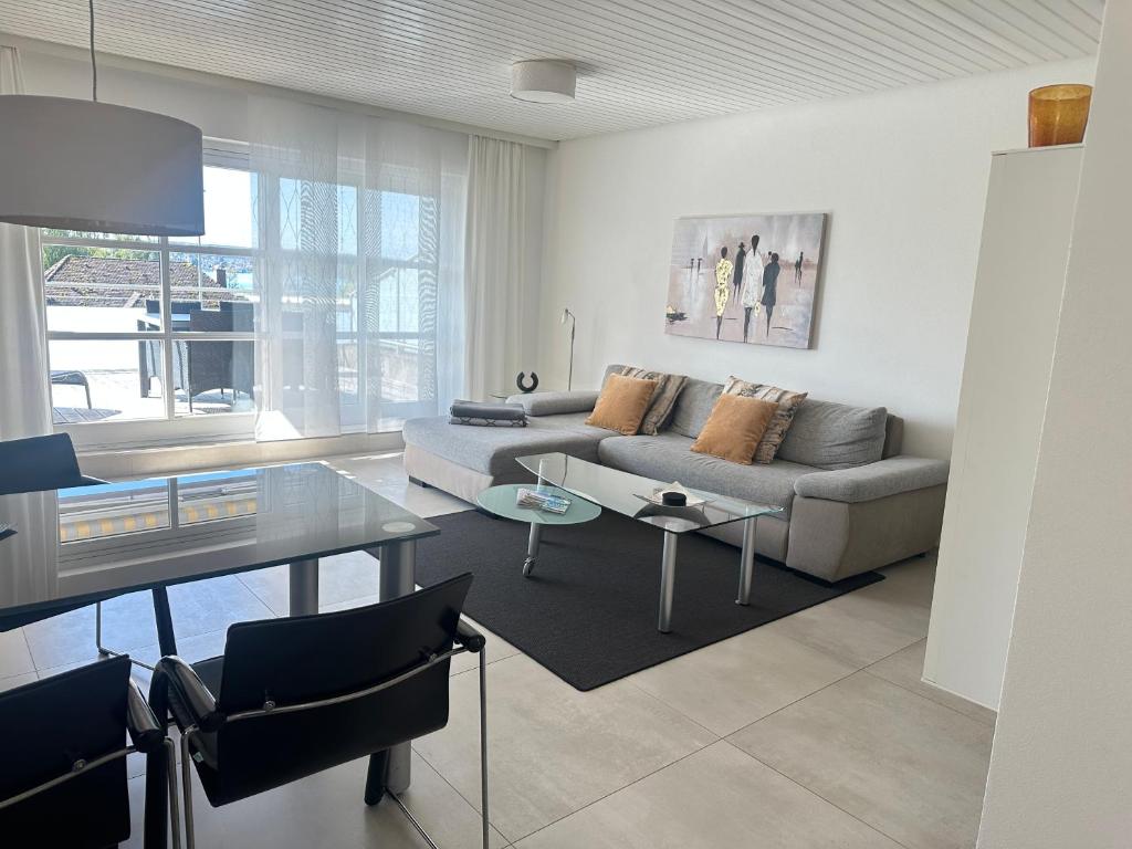 a living room with a couch and a table at Ferienwohnung mit Seeblick und PKW Abstellplatz am Haus in Überlingen