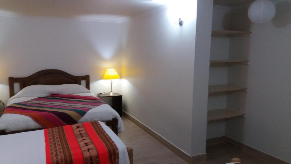 Postel nebo postele na pokoji v ubytování Hostal Nuevo Amanecer