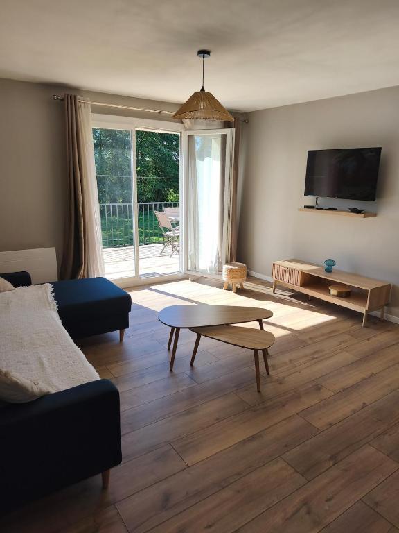 a living room with a couch and a coffee table at Gîte du Bois in Viry-Noureuil