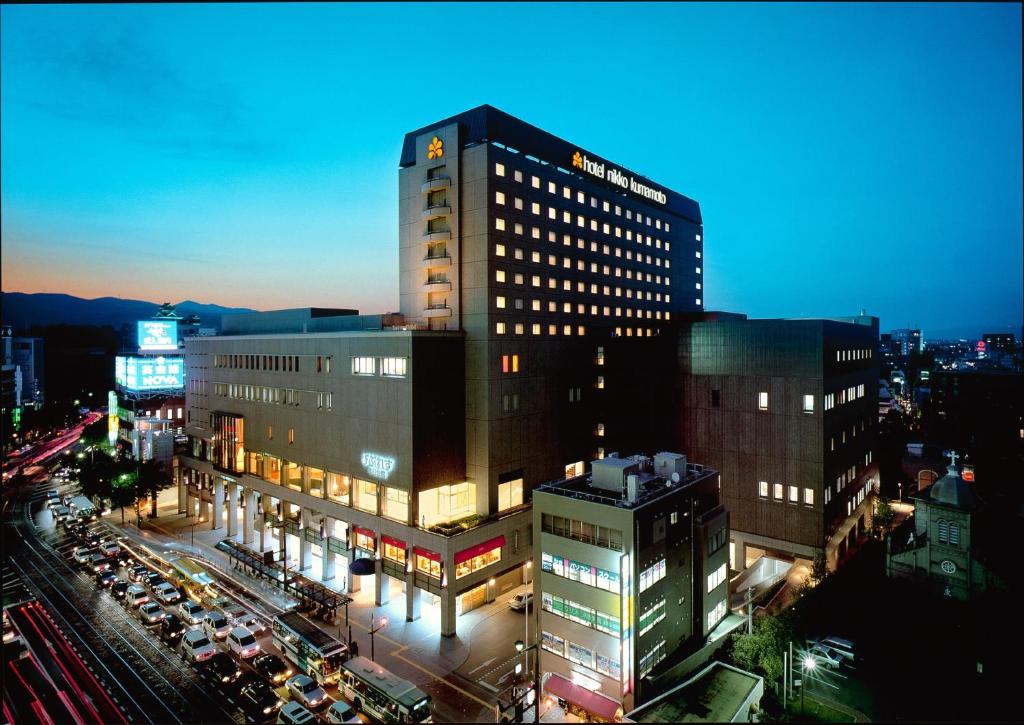 a tall building in a city at night at Hotel Nikko Kumamoto in Kumamoto