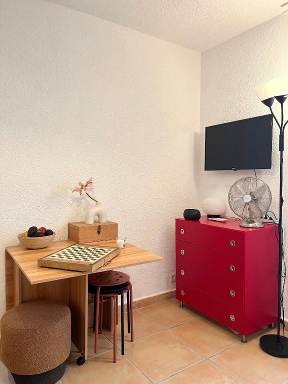 a room with a desk and a red dresser at Maisonette in Saint-Raphaël