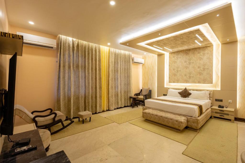a bedroom with a large bed and a window at BUDDHA HERITAGE RESORT in Bodh Gaya