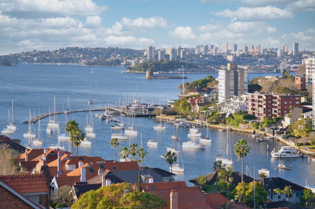 a view of a harbor with boats in the water at Panoramic Harbour View Apartment in Sydney