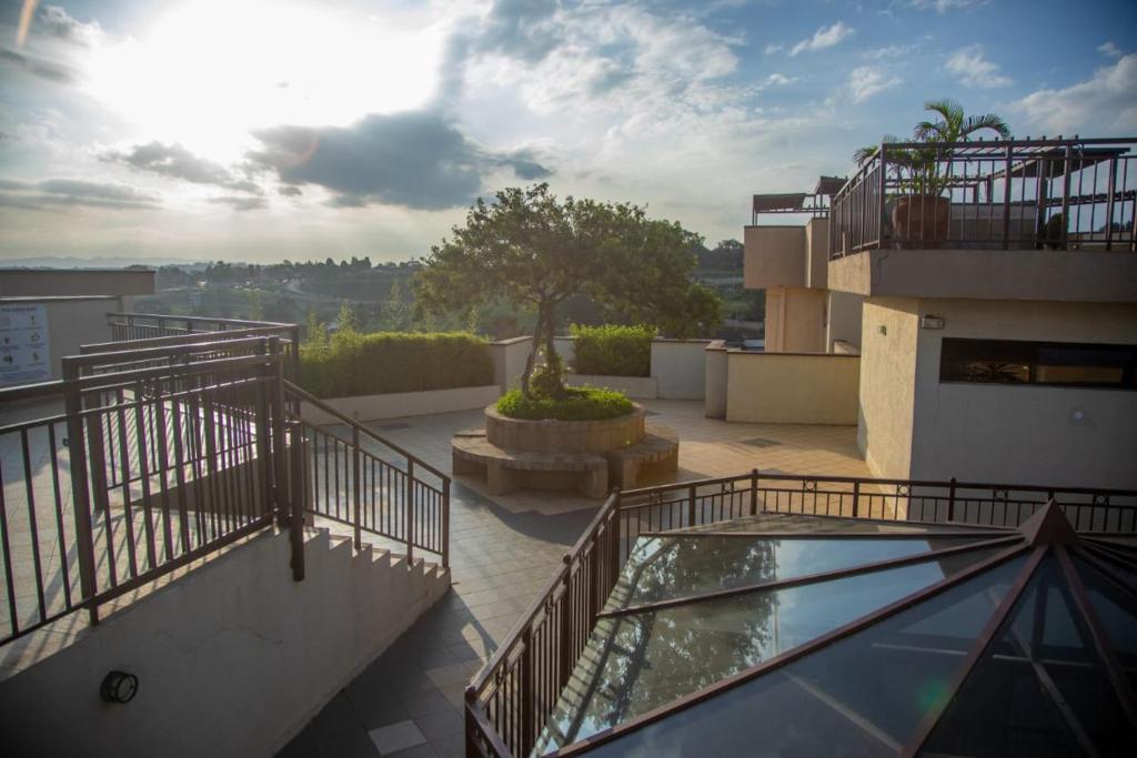 a balcony of a building with a glass floor at Madaraka 1 Westpointe in Nairobi