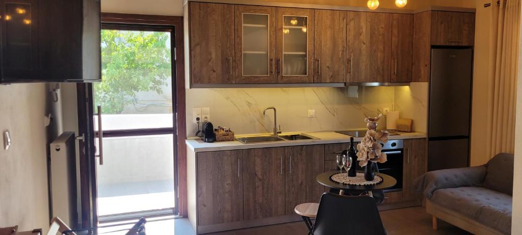 a kitchen with wooden cabinets and a sink and a table at Mountain view in Volos