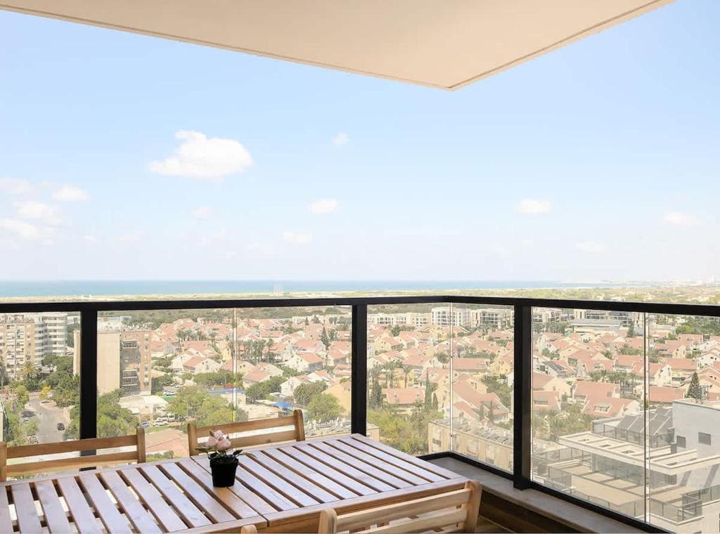 a balcony with a view of a city at 3BR charming on the 14th floor overlooking the sea in Qiryat Yam
