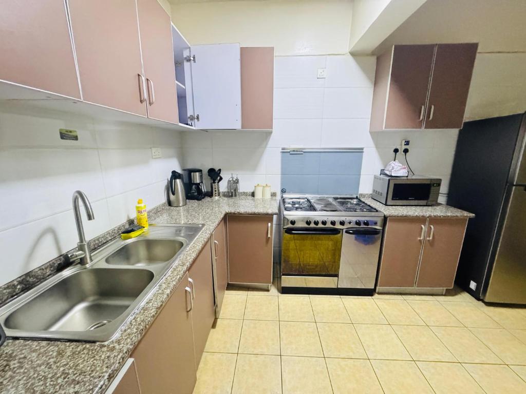 a kitchen with a sink and a stove at Skyhorse condo in Nairobi