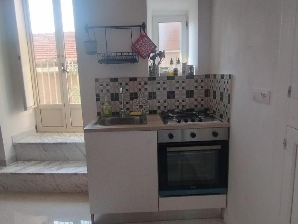 a kitchen with a stove and a sink at Casa Annina in Basilicata in Trivigno