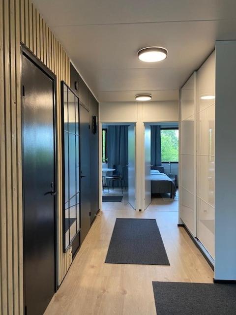 a hallway with a door and a room with a table at Cozy apartment from Raahe! in Raahe
