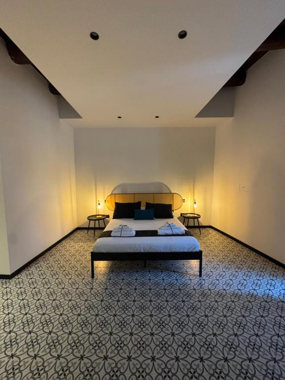 a bedroom with a bed in a room with two tables at Don Raffaé in Nola