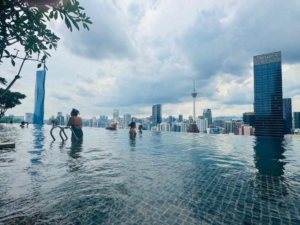 a group of people in the infinity pool of a skyscraper at Axon Residence KLCC At Kuala lumpur in Kuala Lumpur
