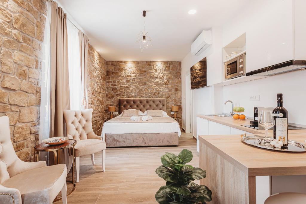 a bedroom with a bed in a room with a stone wall at Four Elements - Water & Earth in Split