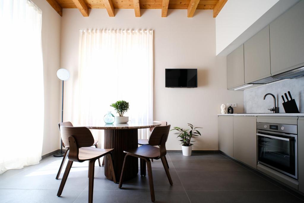 a kitchen with a table and chairs in a room at Premier Stay The Tower - Bernina Experience in Tirano