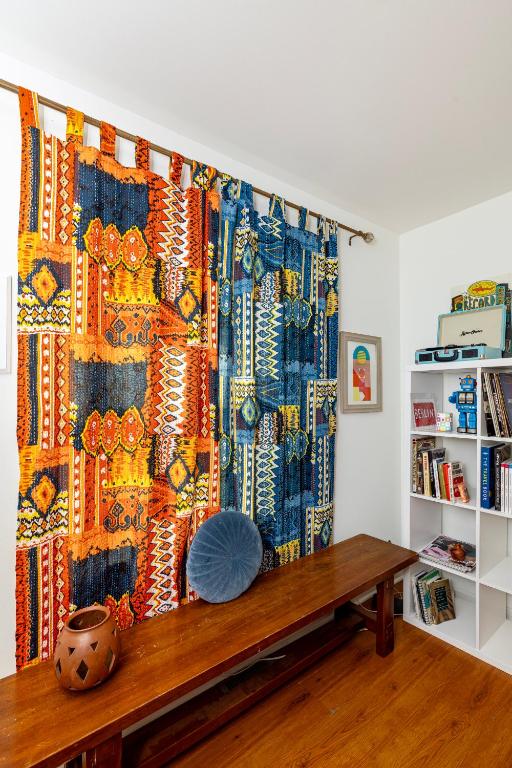 a curtain in a room with a wooden table at Trendy Bohemian Bungalow, Close to Uptown, Plaza & Noda in Charlotte