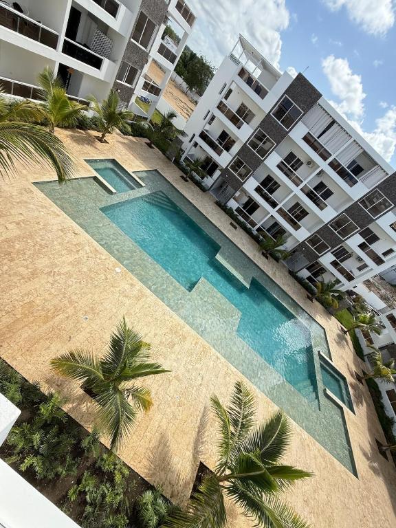 an overhead view of a swimming pool in front of a building at Luxury NEW Stylish apartment Bayahibe with pool in Bayahibe