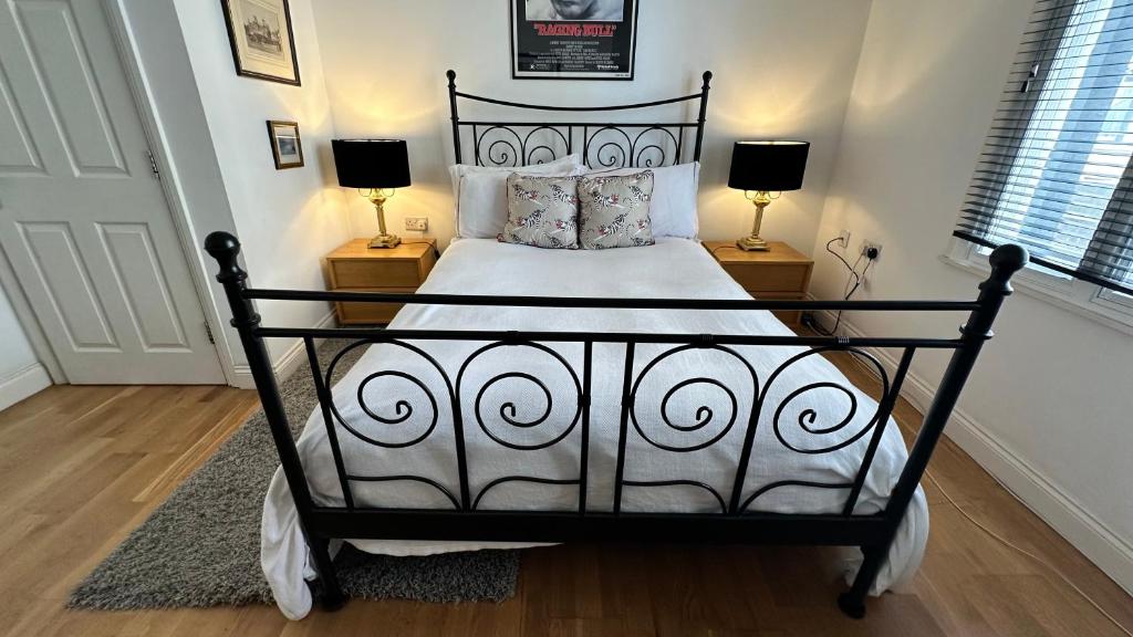 a black and white bed in a room with two lamps at Luxury Room - St Leonards on Sea - East Sussex in Hollington