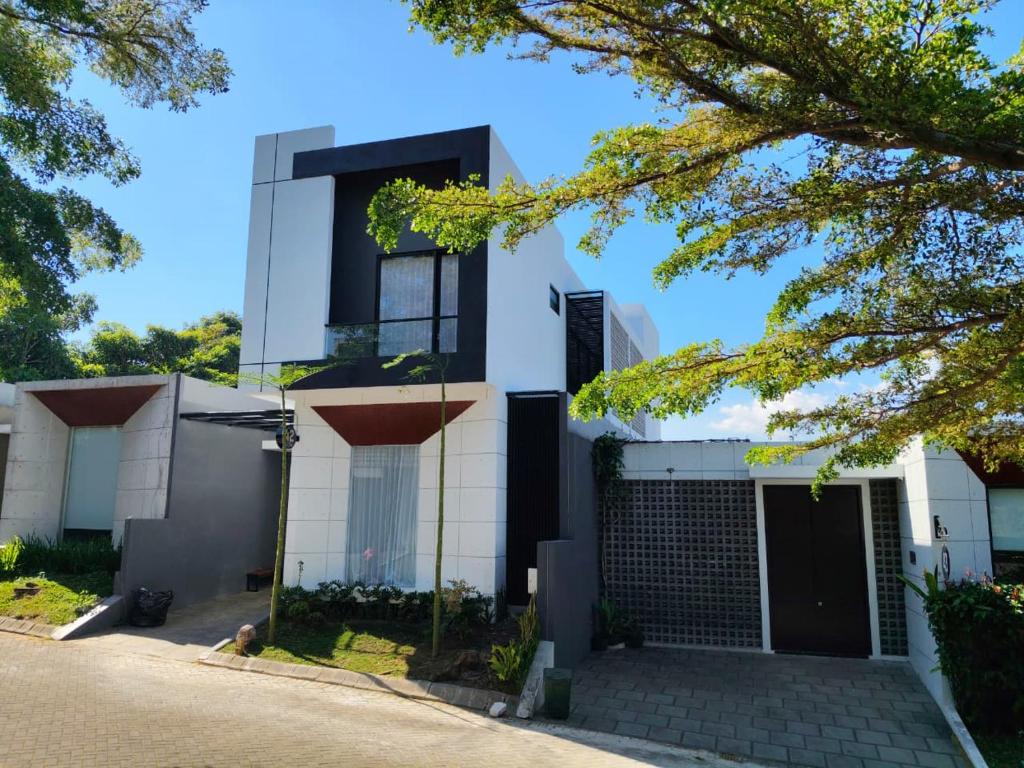 a white house with a driveway at Reindhita Bliss Villa Batu in Batu