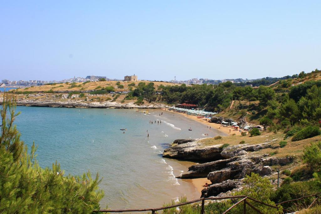 a beach with a bunch of people in the water at Green Garden Eco-Holiday in Vieste