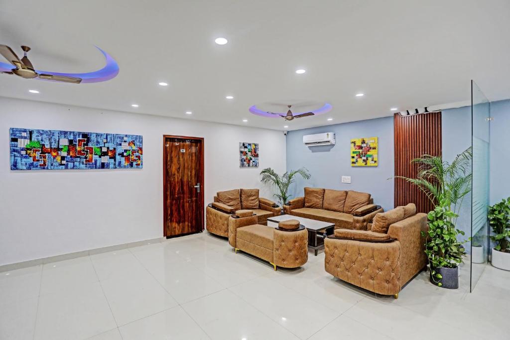 a living room with two couches and a table at Collection O Kanchan Heritage in Gurgaon