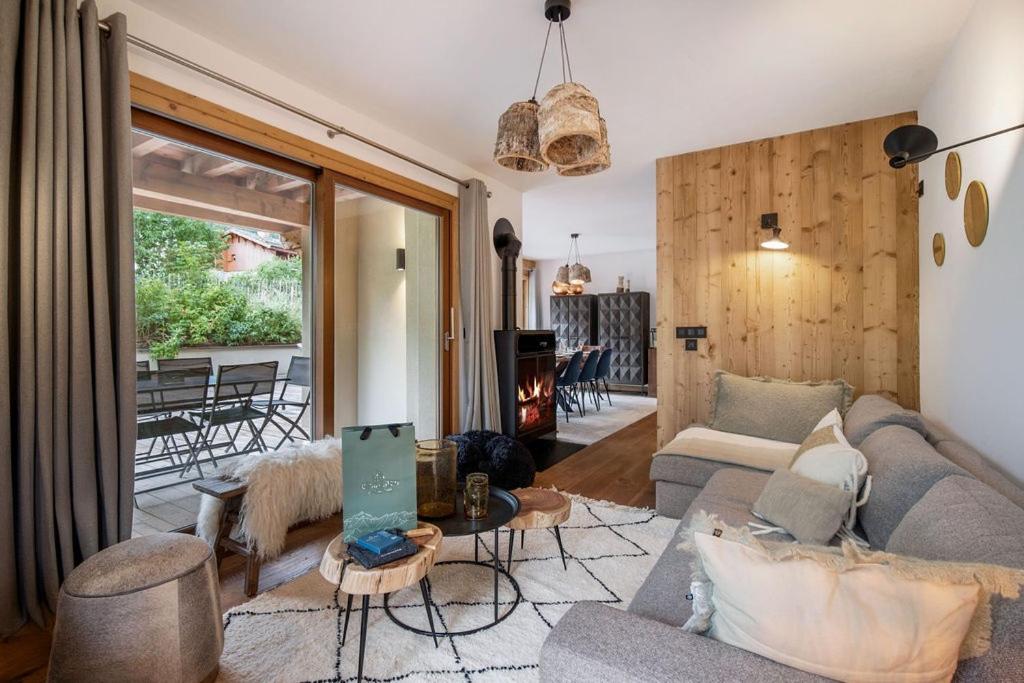 a living room with a couch and a table at Appartement 4 à la Ferme des Lanches au Praz in Courchevel