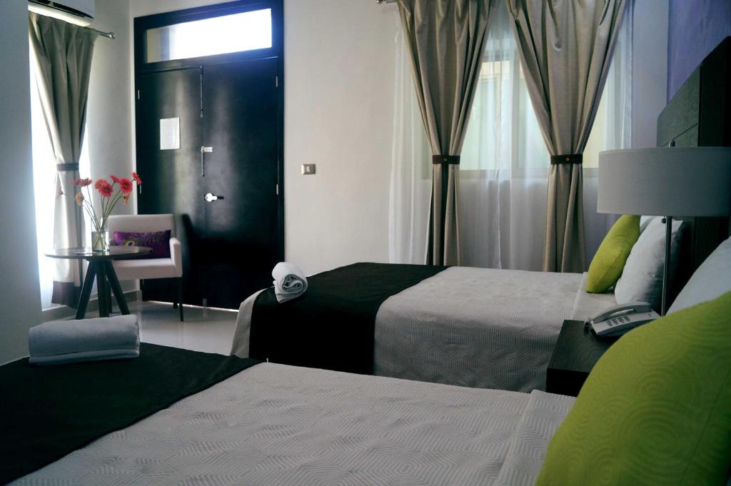 Postel nebo postele na pokoji v ubytování Hotel Casa Palomino