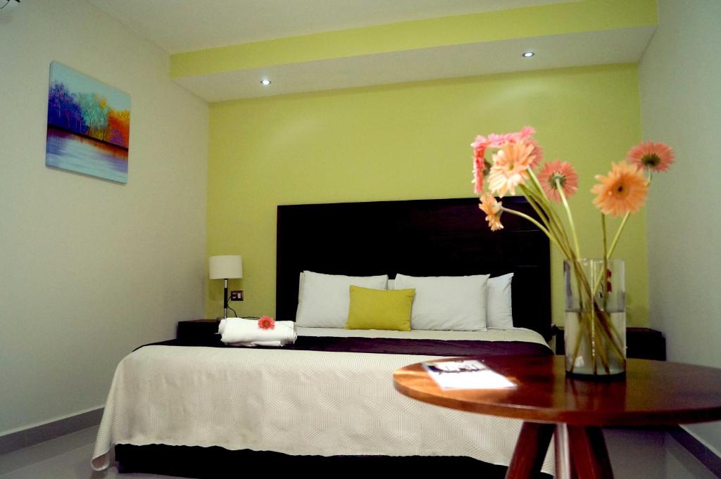 Postel nebo postele na pokoji v ubytování Hotel Casa Palomino