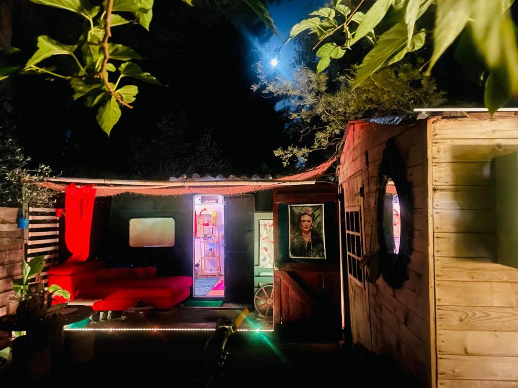 a small house with a red couch in front of it at Logement indépendant avec parking dans un quartier de standing proche de la plage in Les Lecques