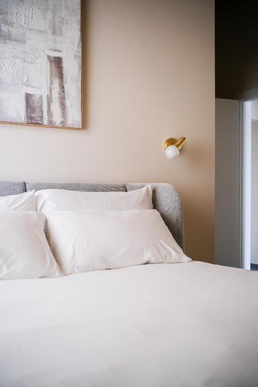 a bedroom with a bed with white pillows at Tower Double Suite - 3 min walk to Bernina Express in Tirano